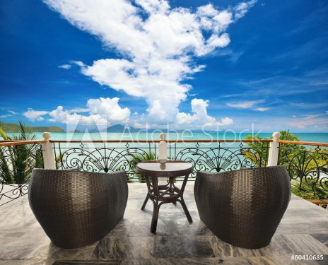 Terrace lounge with rattan armchairs and seaview.