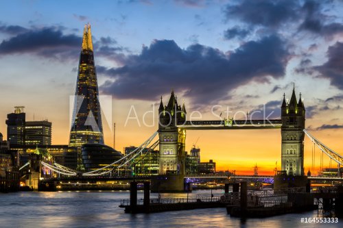 Tower Bridge, the Shard, city hall and business district in the background at night, London, Uk.