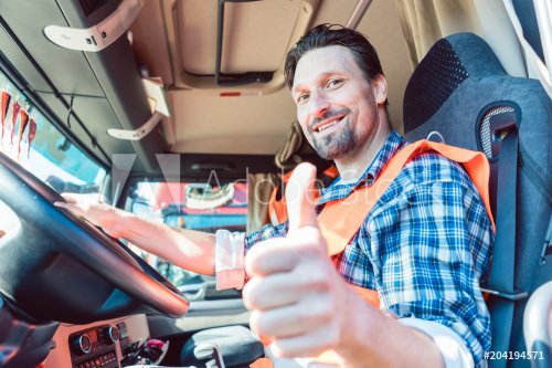 Truck driver man sitting in cabin giving thumbs-up  - 901152642