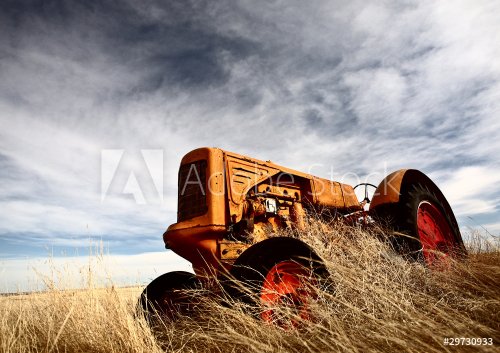 Tumbleweeds piled against abandoned tractor - 901148853