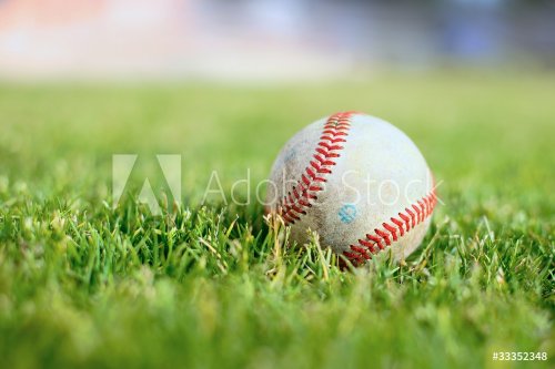 Used baseball on a green grass field