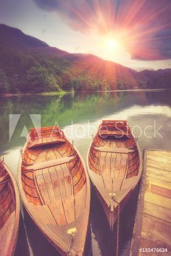 View of glacial mountain Lake Biogradsko, wooden pier and boats in forest. Bi... - 901149838