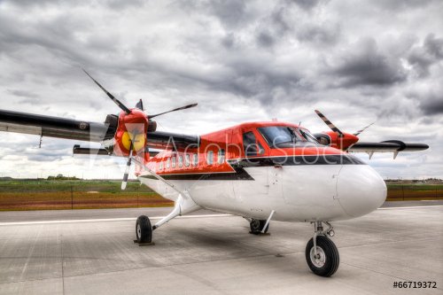 Vintage Propeller Plane on an Airport Tarmac - 901146755
