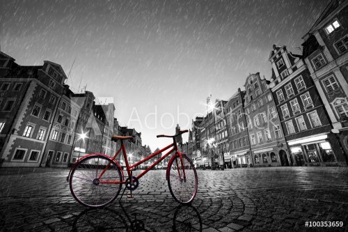 Vintage red bike on cobblestone historic old town in rain. Wroclaw, Poland. - 901152783