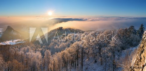 winter sunset over the clouds with sun