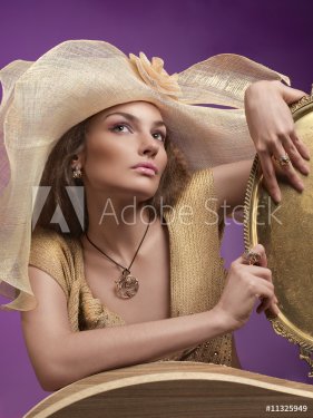 Woman in a hat. A female model wearing a big floppy hat. - 900671745