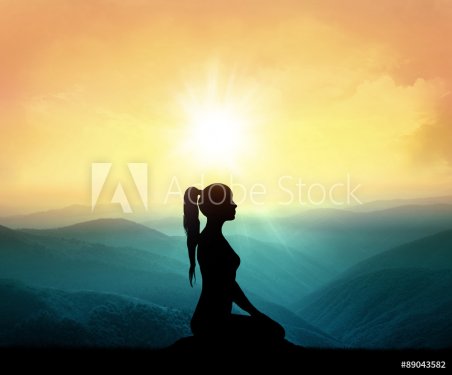 Yoga and meditation. Silhouette of woman in mountains.