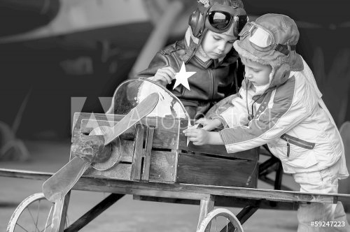 Young Aviators in aircraft in a hangar - 901144114