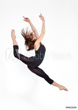 young beautiful ballerina on a gray background - 900377608