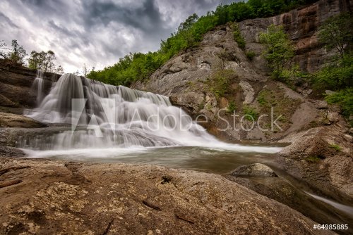 Beautiful waterfall among cliffs