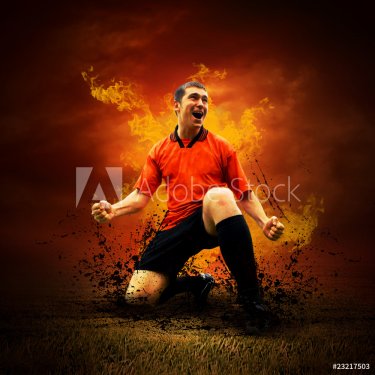 Football player in fires flame on the outdoors field - 900454108