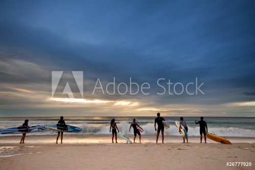 group of surfers preparing for their morning exercise