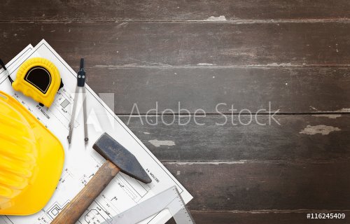 House construction tools on wooden table with free space for text.