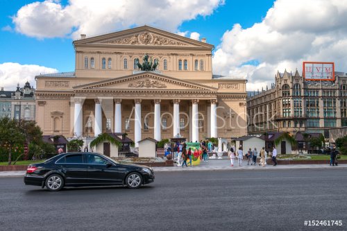 Moscow, Russia - 16 August 2016: Bolshoi Theater, Ohotniy Ryad street. The most famous theatre of Russia. Thousands of tourists annually visit the theatre in Moscow. Luxe car in front of the theater.