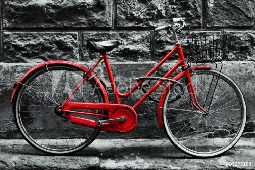 Retro vintage red bike on black and white wall.
