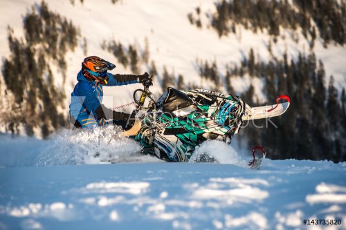 Rider on the snowmobile in the mountains. active drive