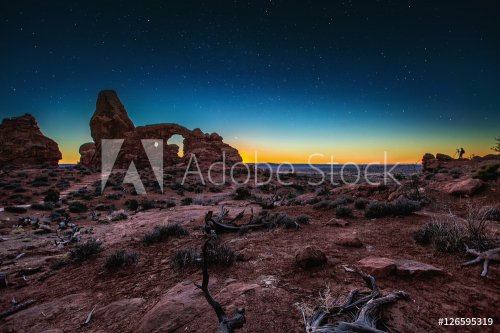 Rock Formations In Remote Desert Landscape Under Starry Night Sky - 901149653