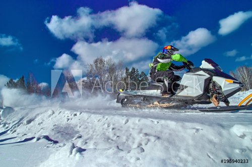 Sports snowmobile is riding at high speed. Extreme competitions on a sunny wi... - 901151611