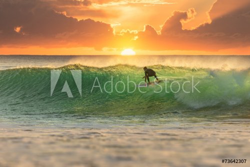Surfer Surfing at Sunrise - 901148779