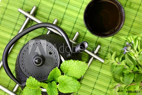 Tabletop with oriental teapot and cup with fresh herbs - 901142015