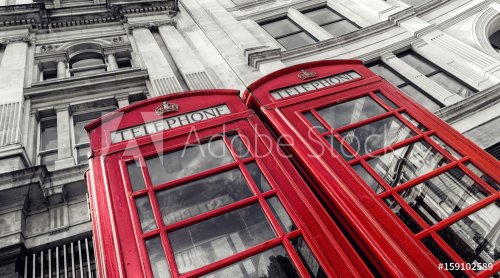 two traditional red telephone booths in London city  - 901152772