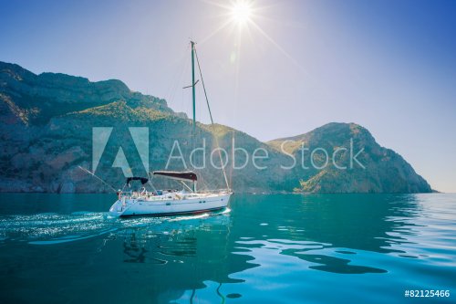 Yacht sailing along the shore the sea in calm weather. - 901149485