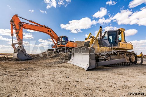 Excavator in a construction site on a sunny day - 901156359