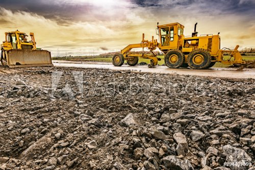 Excavator to level and smooth the land in the construction of a road - 901156357
