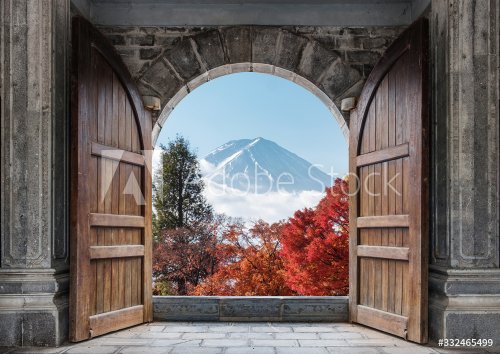 Open large wooden door with mount Fuji-san and autumn maple tree in blue sky