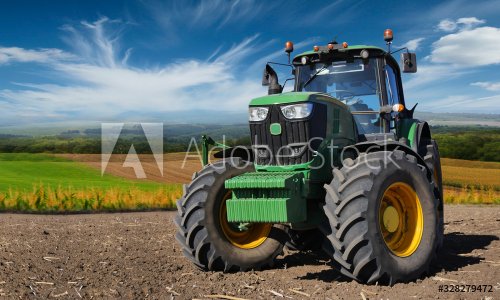Modern, green tractor in the spring field work - 901156783