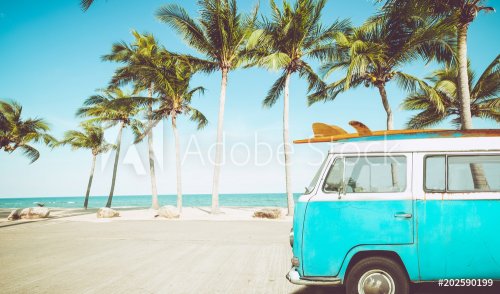 vintage car parked on the tropical beach (seaside) with a surfboard on the ro... - 901157219