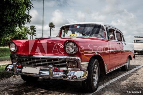 Cuba Varadero red classic car is parked on the side - 901157231