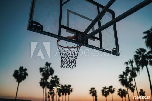 Basketball hoop on the beach at sunset