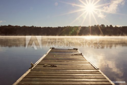 Cottage Dock over looking the clam lake water on a misty morning with the sun... - 901157258