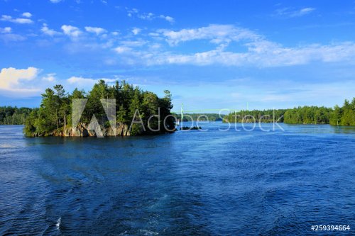 Peaceful landscape of the Thousand Islands during summer with bridge in background along Canadian American border