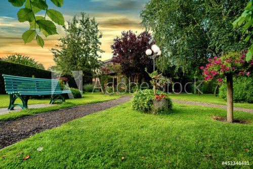 Dreamlike garden design with grass, paths, flowers and other plants - 901157261