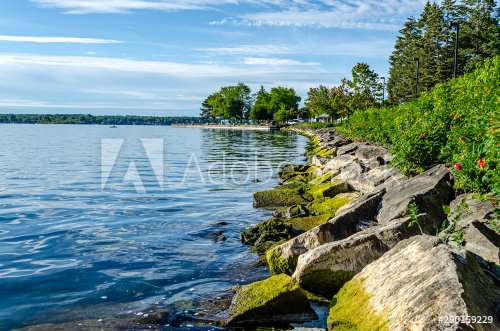 Rock lined coastline on the shore of Brockville, Ontario on the St. Lawrence River