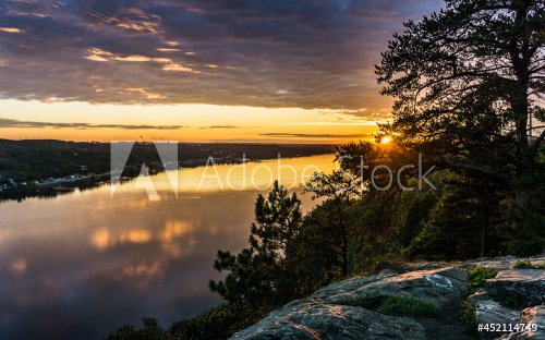 Sunset over the Saguenay river in Chicoutimi (Quebec, Canada), on a cloudy su... - 901157291