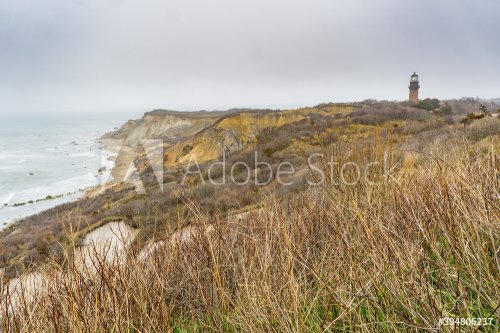 Aquinnah Cliffs on Martha's Vineyard, Massachusetts, on cloudy and foggy day. A lighthouse can be seen in the background