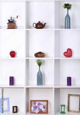 Beautiful white shelves with different home related objects - 901157392