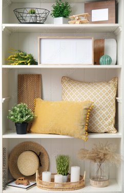 White shelving unit with plants and different decorative stuff - 901157394