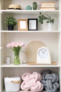 White shelving unit with plants and different decorative stuff - 901157395