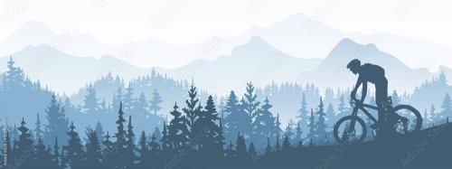 Silhouette of mountain bike rider in wild nature landscape. Mountains, forest in background.