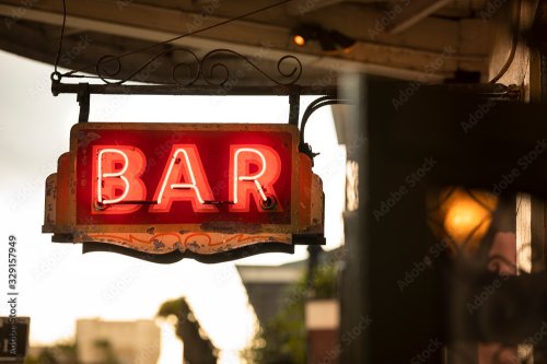 Neon bar sign hangs along Bourbon Street in the French quarter of New Orleans... - 901157692