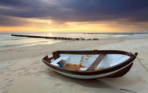 Boat on beautiful beach in sunrise - 900003326