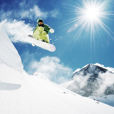 Snowboarder at jump inhigh mountains - 900029615