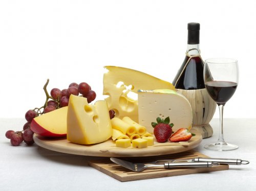 Cheese still life on a wooden round tray - 900043644