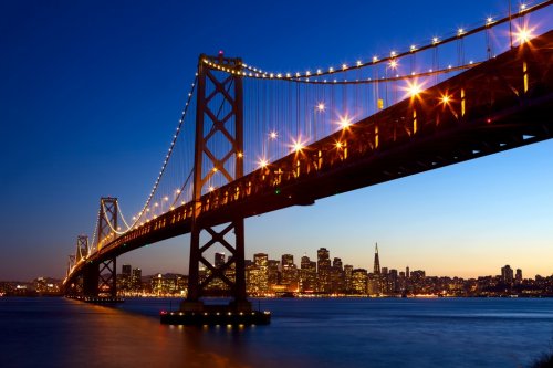 San Francisco skyline and Bay Bridge at sunset, California, USA - 900066805