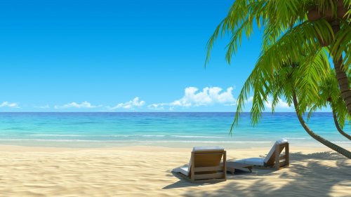 Two stylish beach chairs on idyllic tropical white sand beach