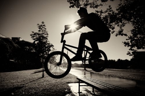 boy jumping over bench  on bmx - 900094655